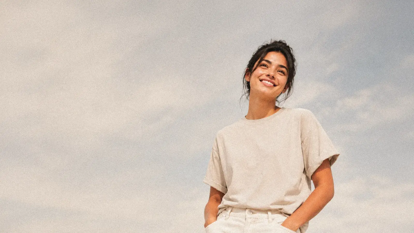 Woman smiling outdoors, at ease after starting online thyroid care